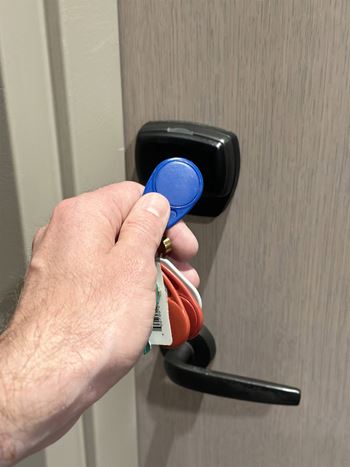 a hand is holding a key in a door handle